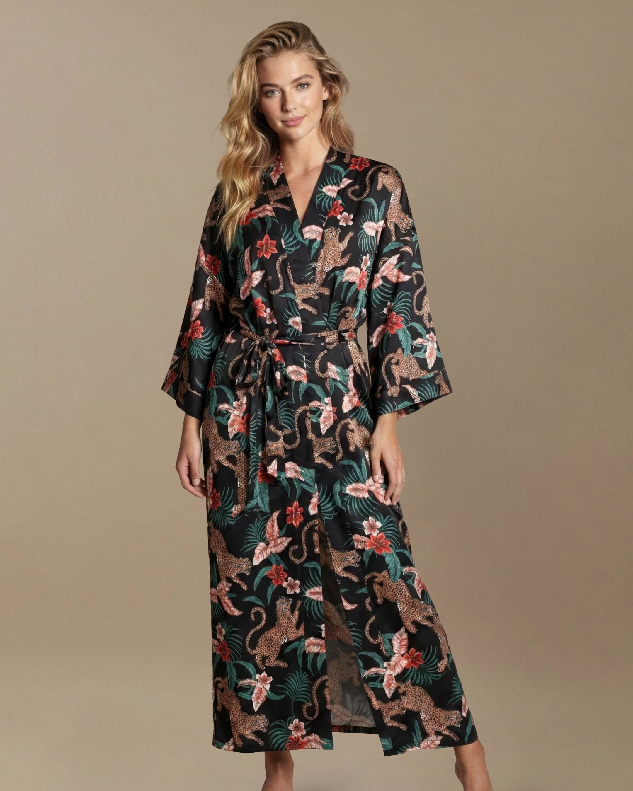 Woman wearing a floral kimono-style dress against a beige background