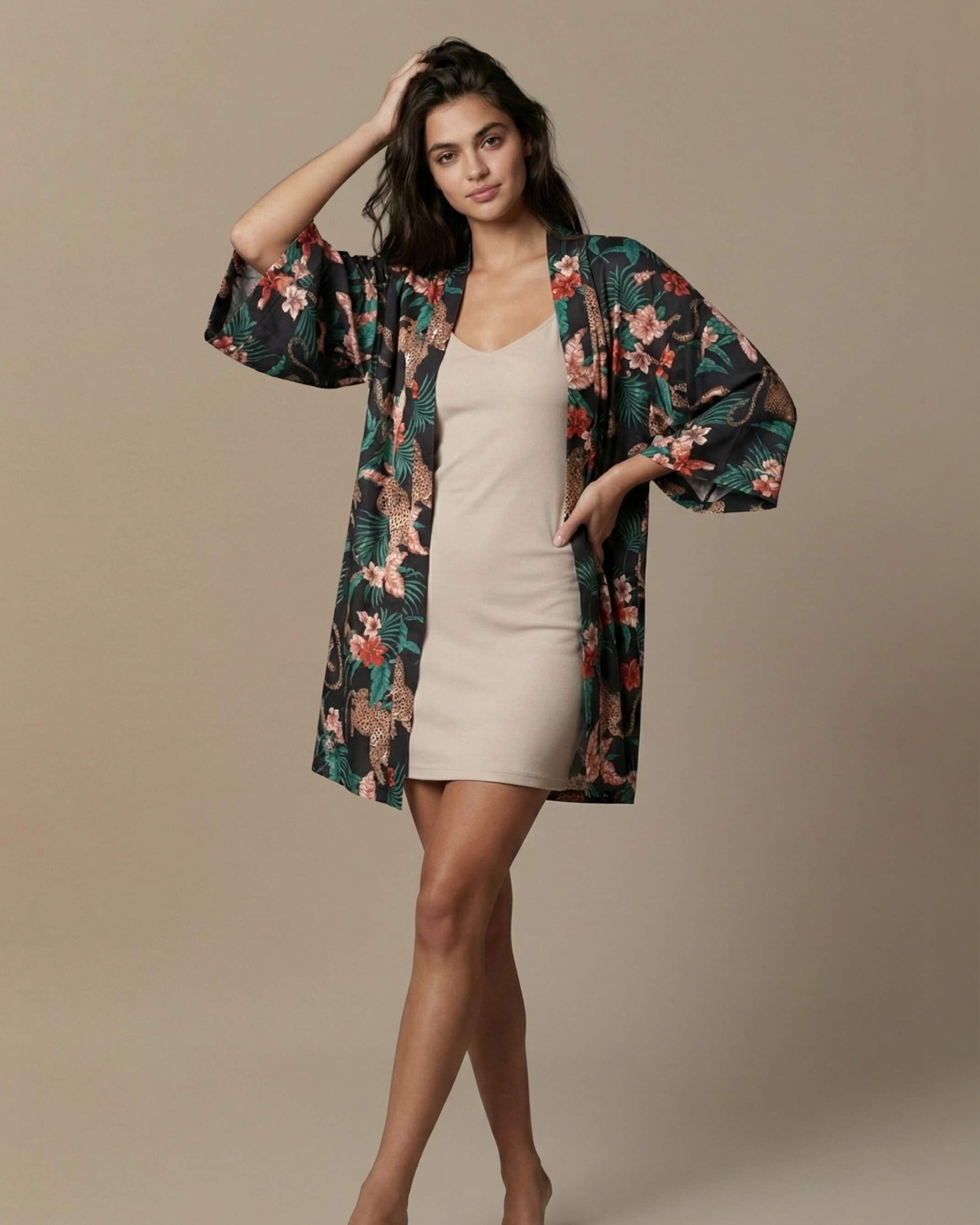 Woman wearing a floral kimono over a white dress on a beige background